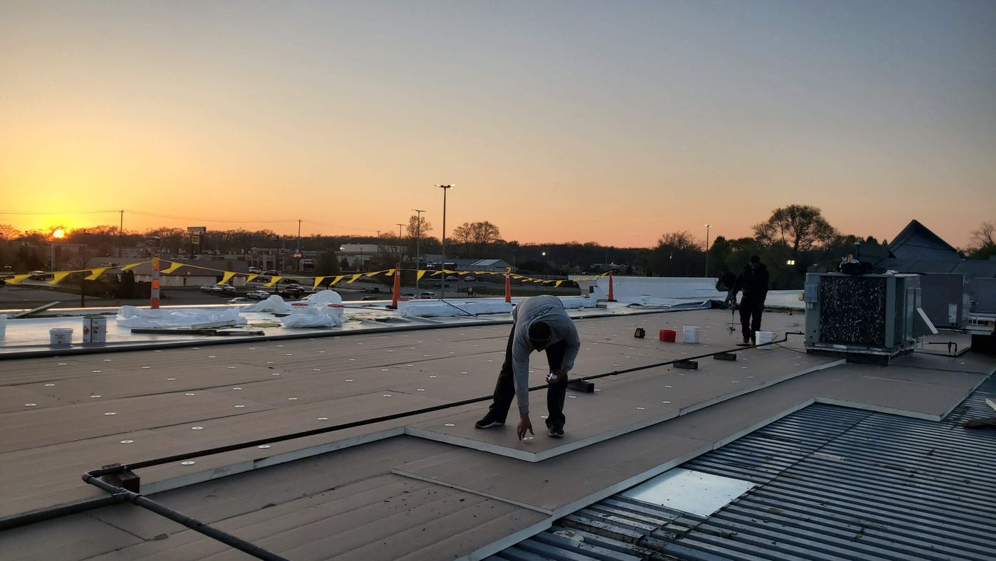 Revolve crew working a commercial flat roof at sunset in St. Louis