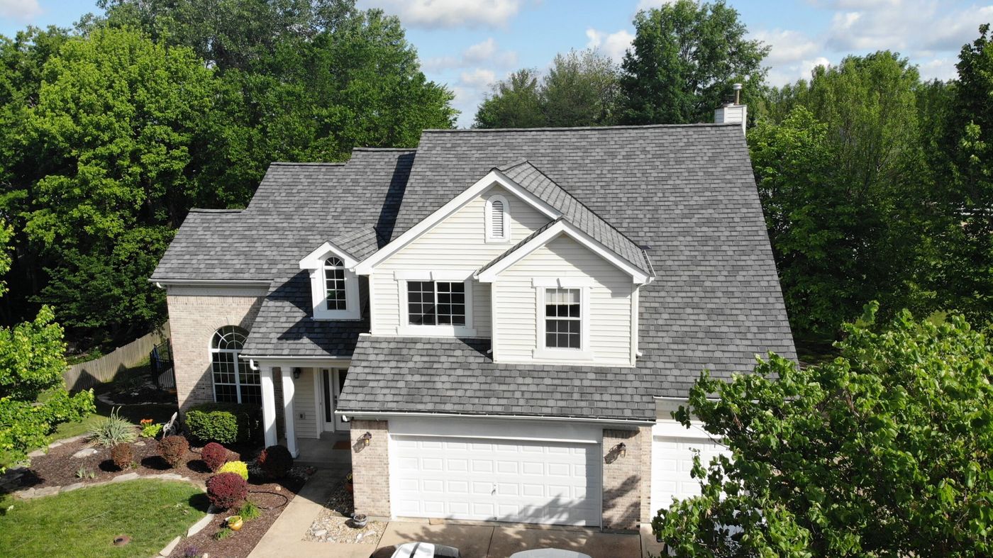Aerial view of a new architectural shingle roof on a two-story home